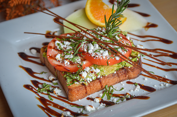 Vegetarian avocado toast with tomato, feta, and balsamic drizzle at Hash House A Go Go at The LINQ in Las Vegas.