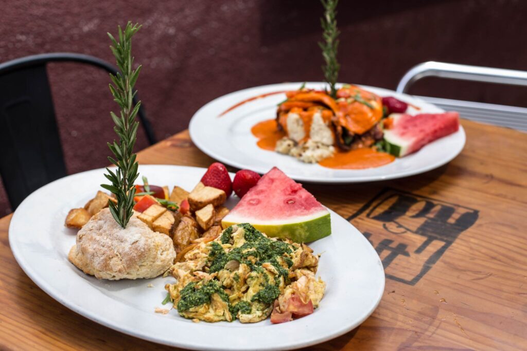 Breakfast dining at Hash House A Go Go at The LINQ featuring chilaquiles, corned beef hash, scrambled eggs, and crispy bacon.