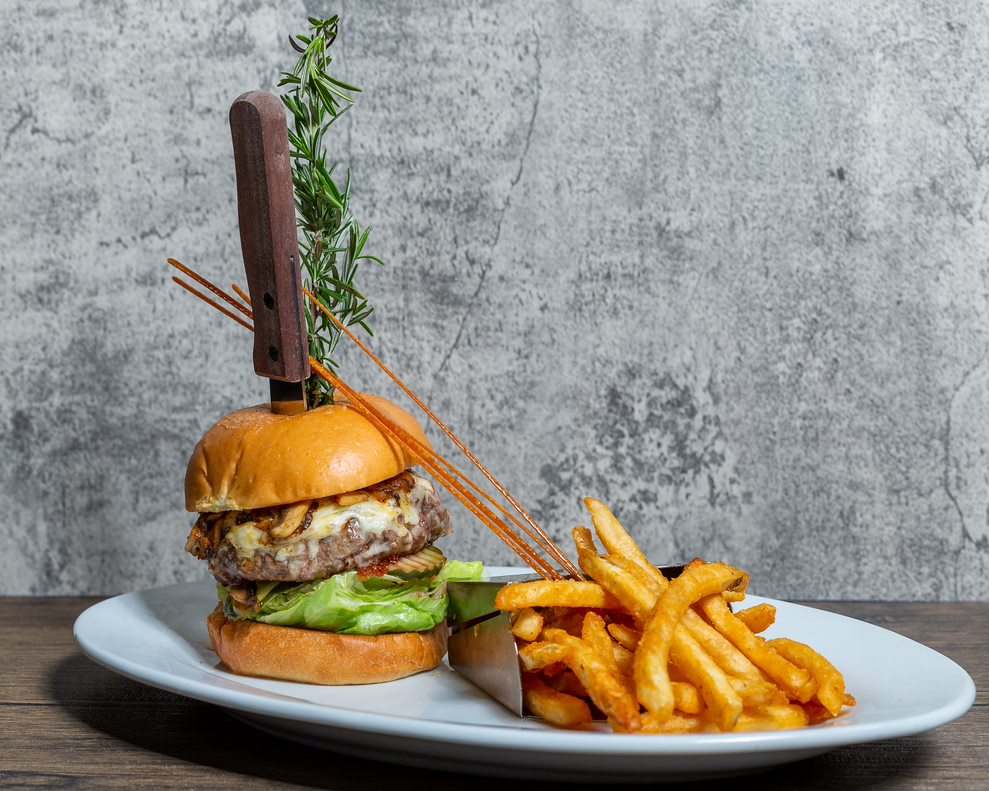 Hash House A Go Go Twisted Burger with cheese, lettuce, and crispy fries at The LINQ Las Vegas.