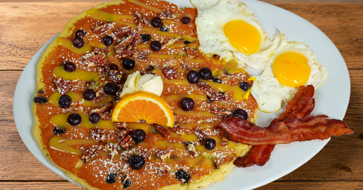 Blueberry Pecan & Lemon Glaze Flapjack with blueberries, candied pecans, eggs and bacon at Hash House A Go Go at The LINQ Las Vegas